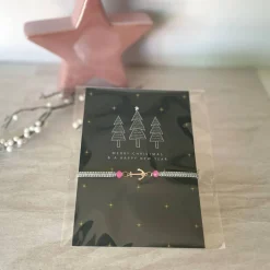 Filigran geknüpftes Armband in Grau mit Anker-Element in Roségold, Glasschliffperlen in Rosa, Weihnachtskarte