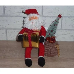 gehäkelter Weihnachtsmann mit Geschenken auf einer Holzbank