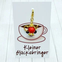 Glücksbringer Kanne goldfarben / rot – Charm für Tee- & Kaffee-Liebhaber