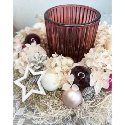 Haltbares Adventsgesteck mit Windlichtglas in kräftigen Beeren-, und rosatöne