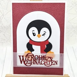 Handgemachte Weihnachtskarte A6 mit Pinguin und rotem Schal – liebevoller Wintergruß in Rot-Weiß“