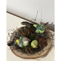Osterdeko auf einer Baumscheibe Vogel Frühlingsgesteck