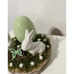 Osterdeko auf einer Baumscheibe Hasen grün