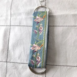 Rockheber aus blaugrauem Baumwollsatin mit silberner Blütenstickerei – Skirtlifter für Rock & Kleid