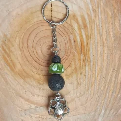 Schlüsselanhänger/Taschenbaumler -zum Beduften- schw. Lavaperlen, Glas-Modulperle und Anhänger ''Blume/Smiley