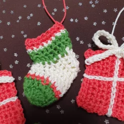 Weihnachtlicher Baumschmuck, gehäkelt in traditionellen Farben rot, grün, weiß