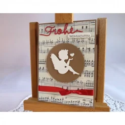 Weihnachtskarte mit Notenpapier, Himmelsbote und Satinband