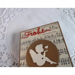 Weihnachtskarte mit Notenpapier, Himmelsbote und Satinband