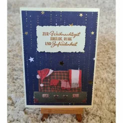 Weihnachtskarte mit Sternen , Koffer mit Weihnachtsmütze
